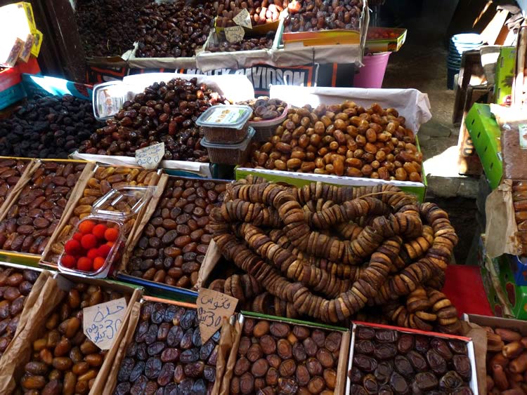 A Medina full of rows of figs, dates, strawberries and tree fruit.