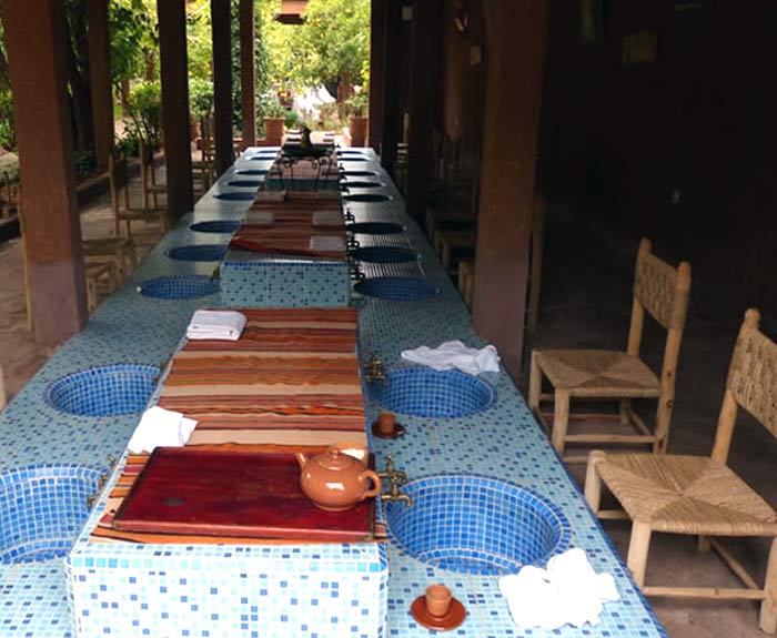 Long, colorful table with basins.