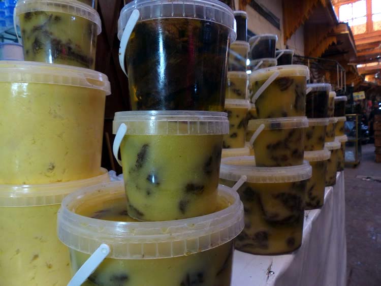 Plastic containers of dried meat packed in fat.
              