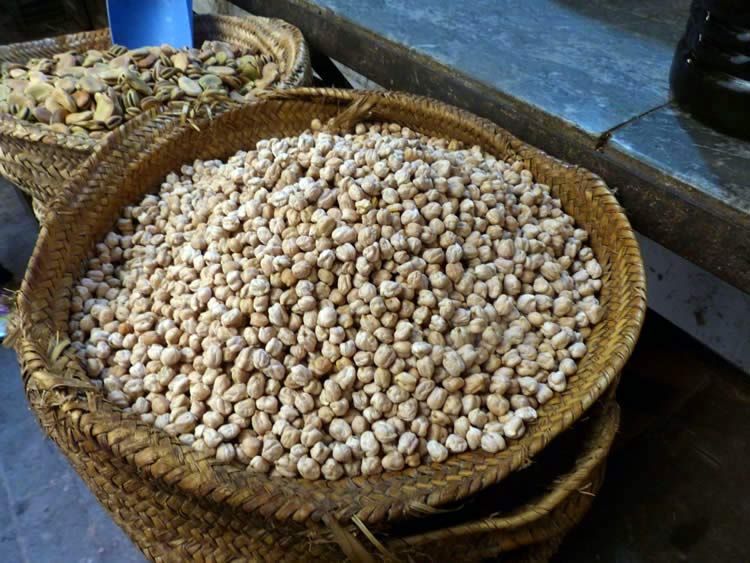 A large woven basket of chickpeas.