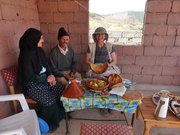 A happy guest with the delicious flatbread and stew on the table