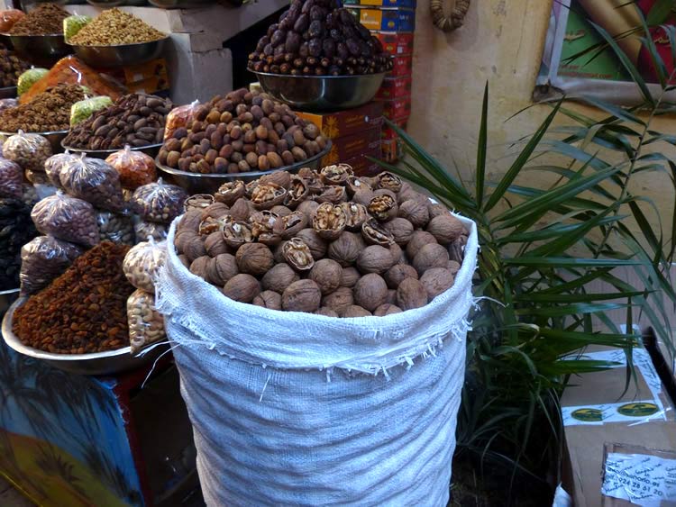 Tall baskets of figs, walnuts, raisins and other dried fruit.