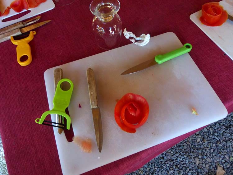 Beautiful tomato roses on a table with a knife.