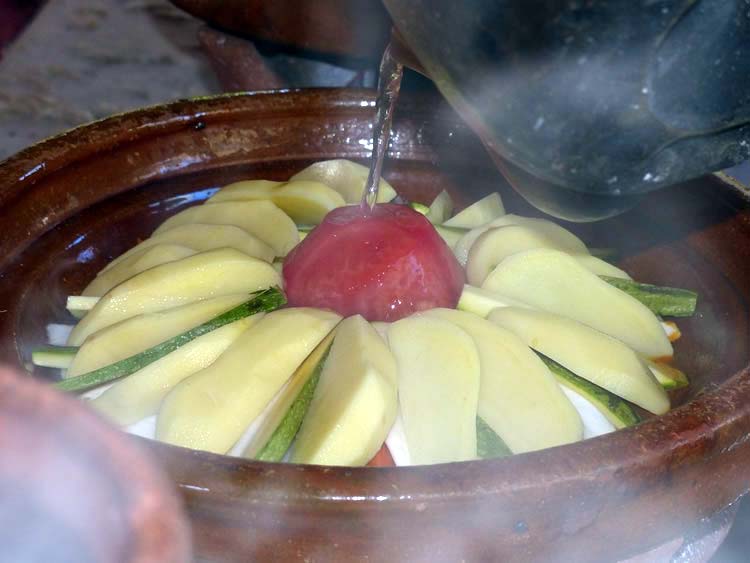 Hot water poured on clay cooker.