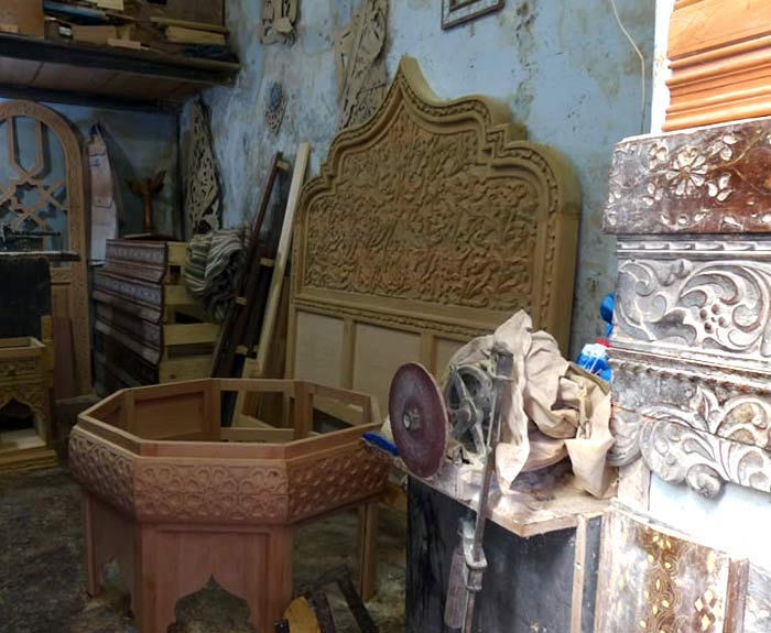 Moroccan headboard and ornately carved wall fixtures.