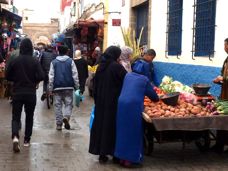 The open air market with local families shopping with the tourists.