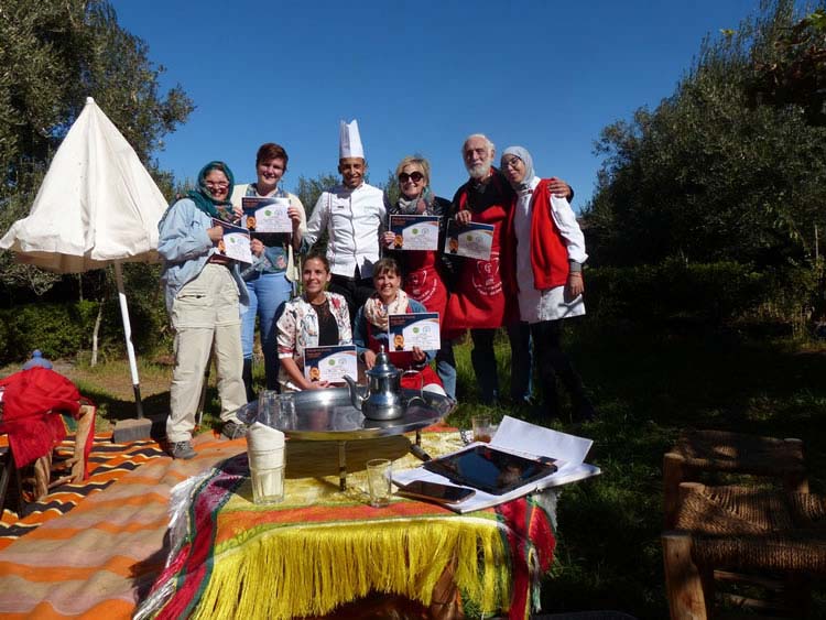 Chefs and students celebrate a successful cooking class with diplomas.