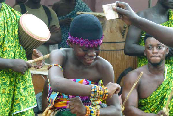 The young female dancer receiving money from the audience