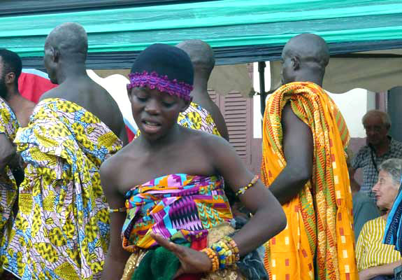 The young dancer with some of the male members of the court lining up behind her.