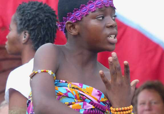 Closeup of the young girl with another member in the background.