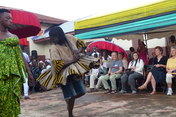 The King's priest dancing and spinning in front of the tourist guests. 