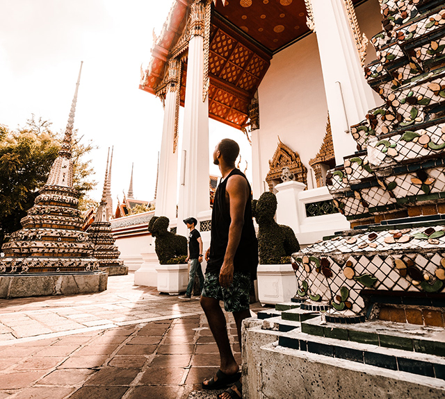 Photo of a Man Standing Near Temple
                        