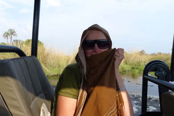 Woman on safari jeep with scarf.