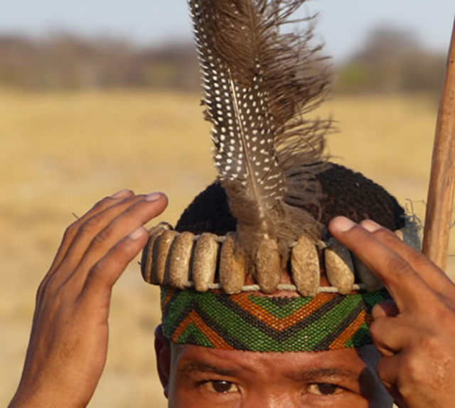 Southern African man with feathered band on his head.