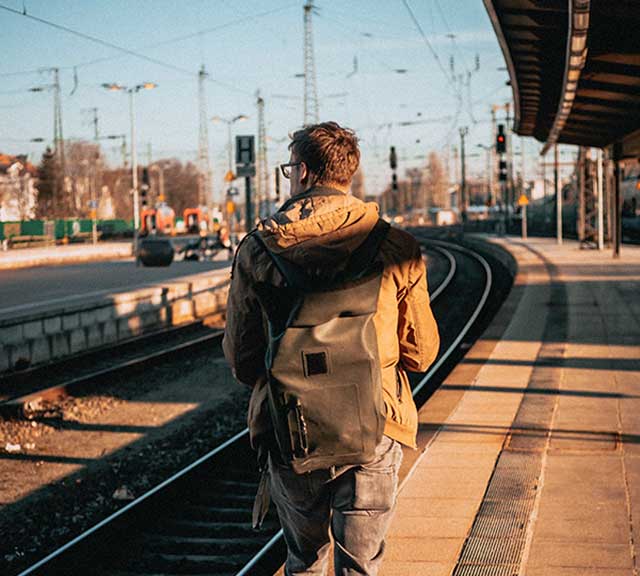 Single man walking to board train.
                      