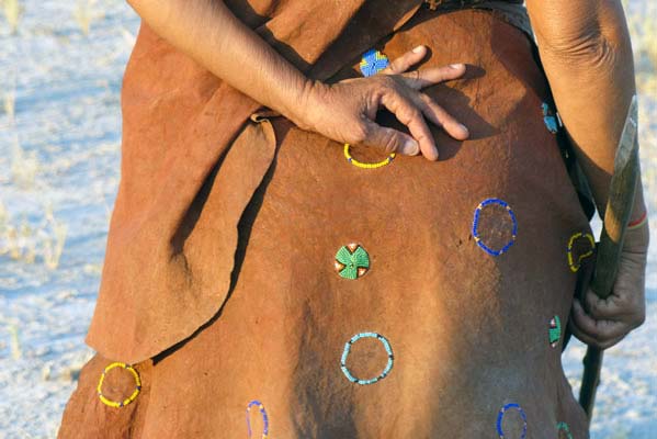 Back of a leather hide wrap with beaded symbols sewn on the leather.