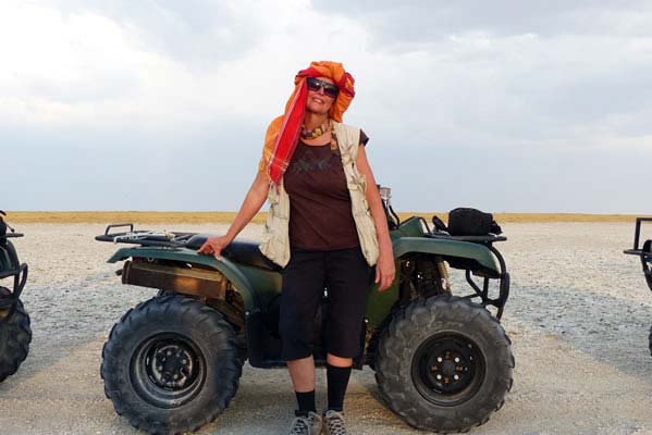 A Safari guest in front of an ATV before taking off in the open desert.