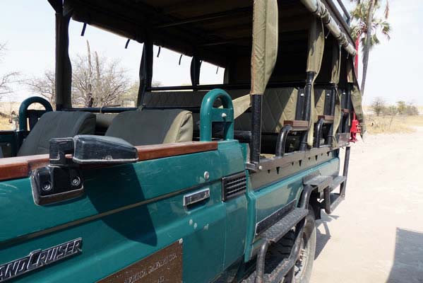 Dark green Land Cruiser waiting to take guests to safari.