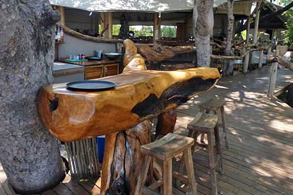 A cocktail table crafted from a tree trunk at Safari Camp.