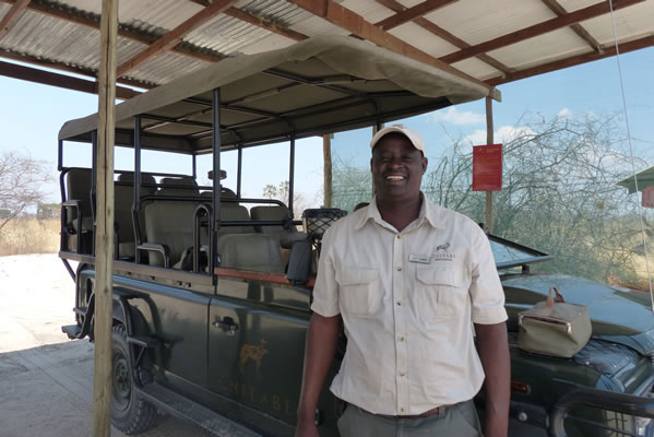 The Safari Camp driver ready to drive the truck in the savanna.