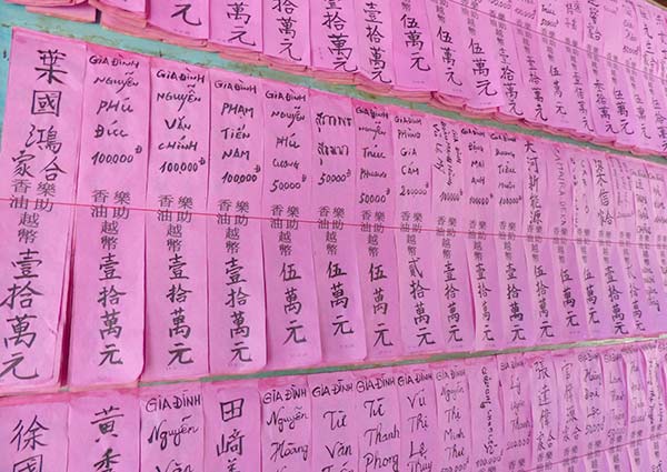 Close-up of the 19th-century Cantoneses; Thien Hau Pagoda's pink wish papers.