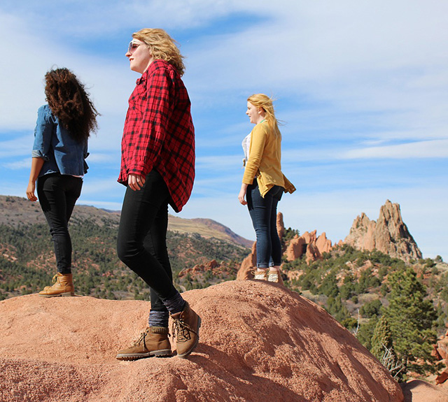 Three women overlooking the desert.