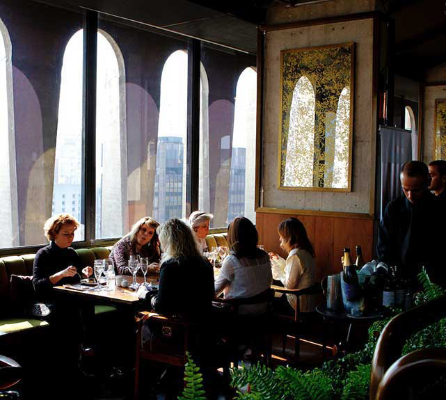 Group of mature women eating in a restaurant